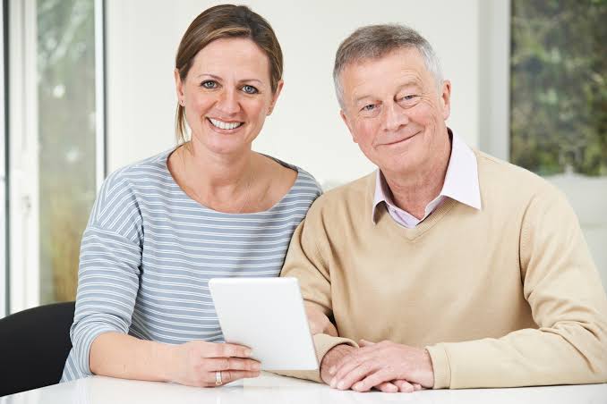 Smiling parents looking at a tablet together